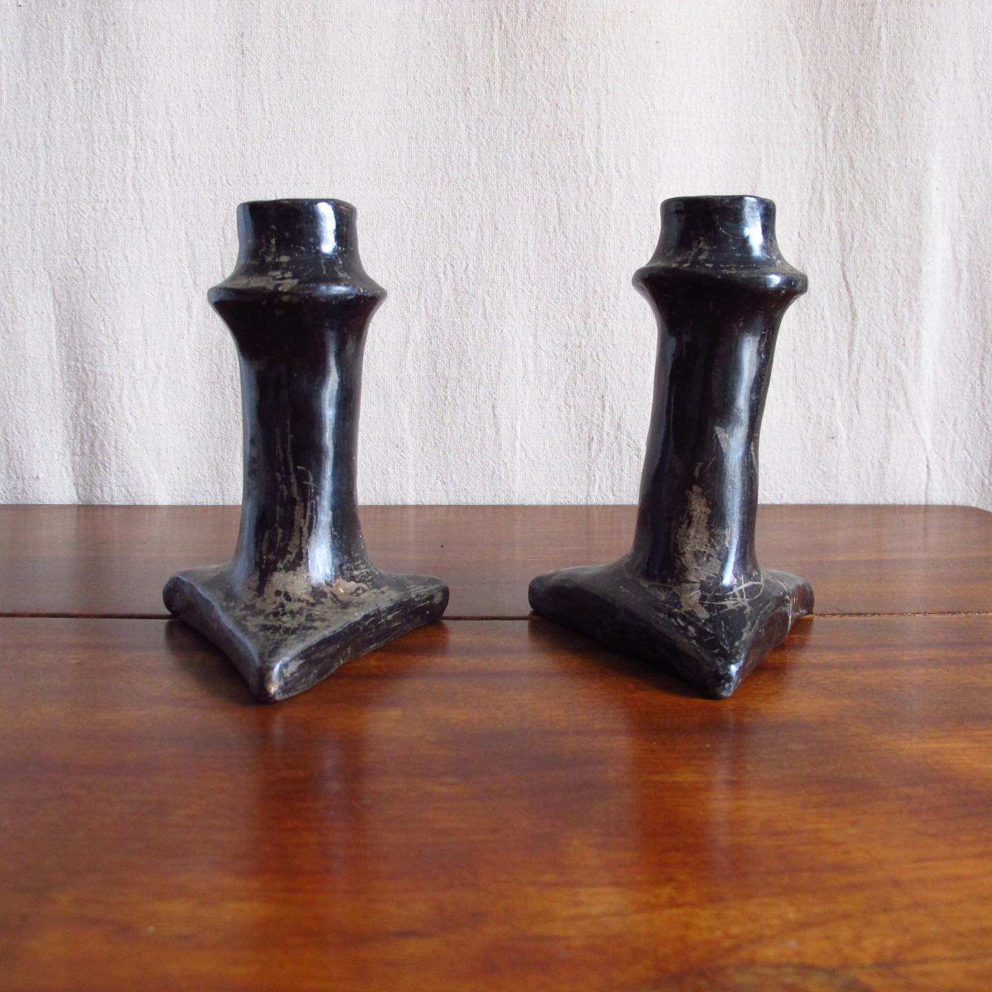 Pair of Southwest Santa Clara black Native American pottery candlesticks, c. 1920