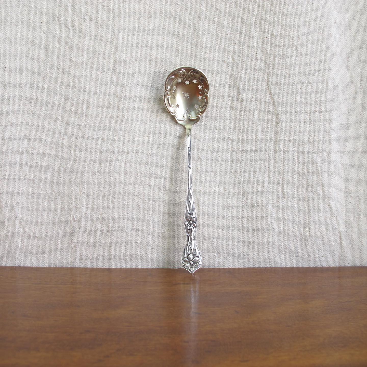 Sterling spoon slotted with stars, handle with daffodils in extraordinary detail, by MANCHESTER MFG. CO, c. 1905