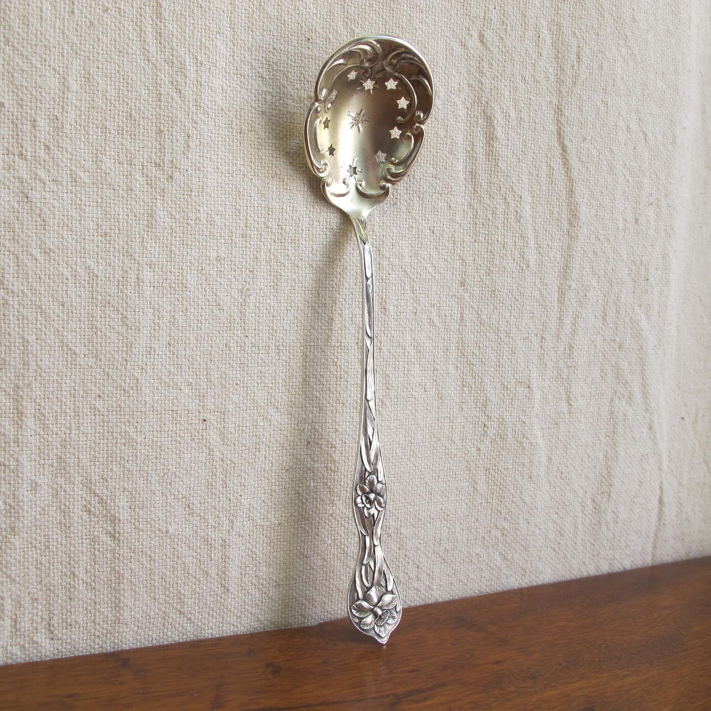 Sterling spoon slotted with stars, handle with daffodils in extraordinary detail, by MANCHESTER MFG. CO, c. 1905