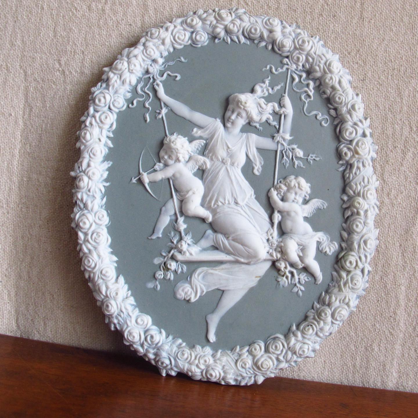 Victorian jasperware bisque relief with maiden and putti / cupid playing on a swing, in the manner of Wedgwood, c. 1890