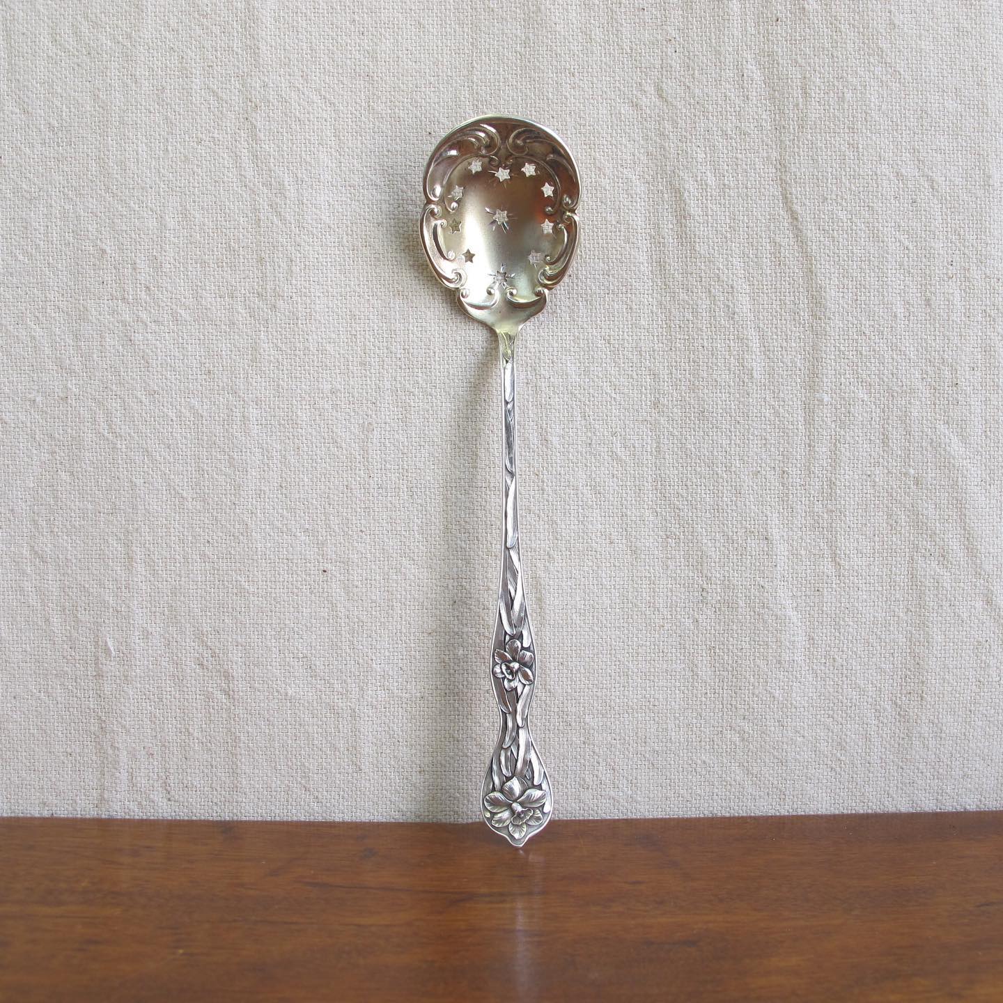 Sterling spoon slotted with stars, handle with daffodils in extraordinary detail, by MANCHESTER MFG. CO, c. 1905