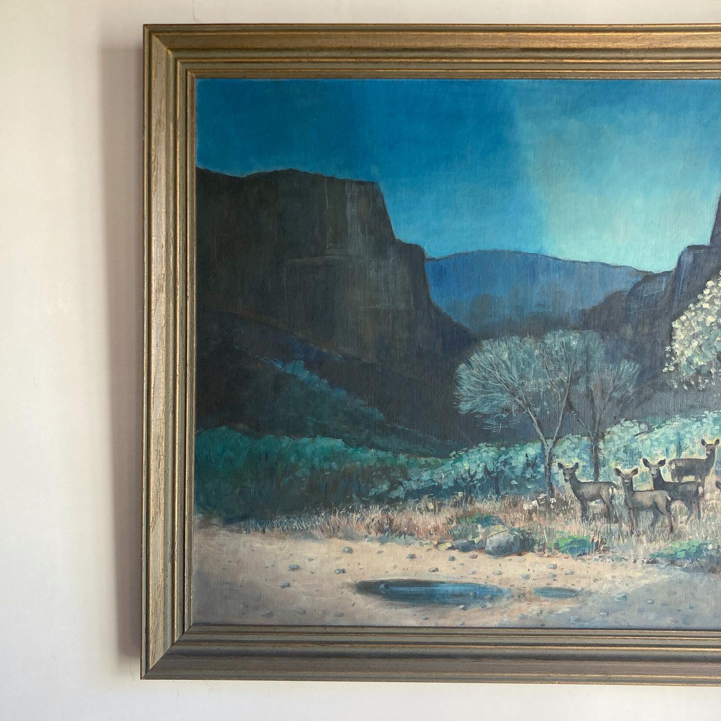 Western American art oil on canvasboard canyon scene with mountain range and a herd of deer at twilight, by Johnson, dated 1967