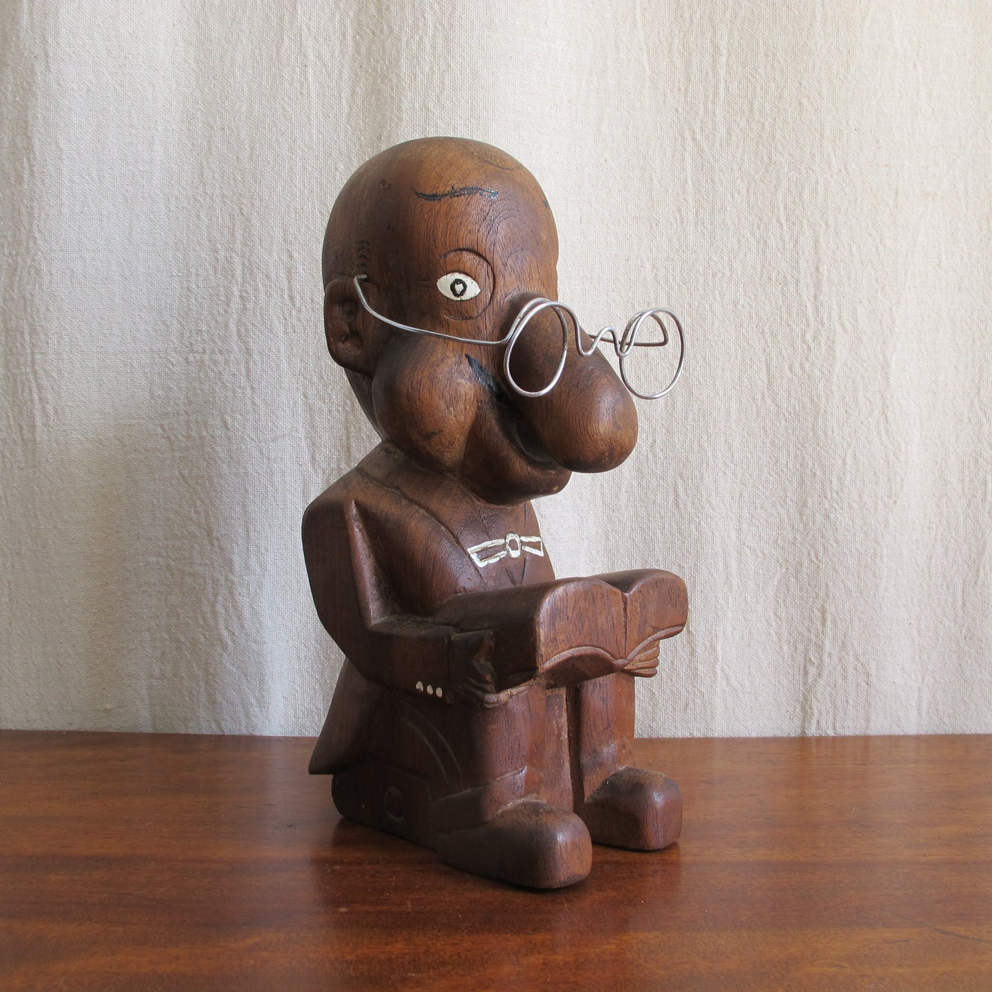 3D caricature of an unknown sitter or character, seated reading with a bulbous nose, suit with tails, glasses, c. 1930 vintage antique