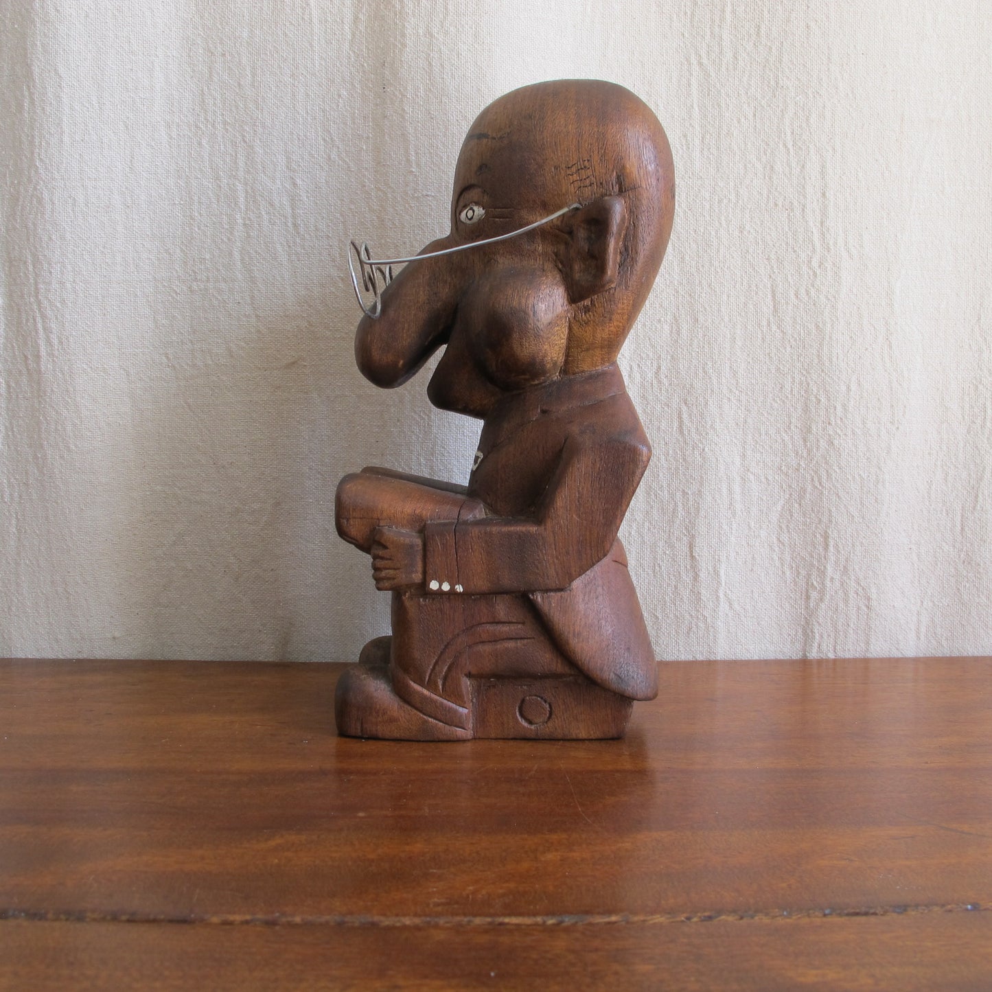 3D caricature of an unknown sitter or character, seated reading with a bulbous nose, suit with tails, glasses, c. 1930 vintage antique