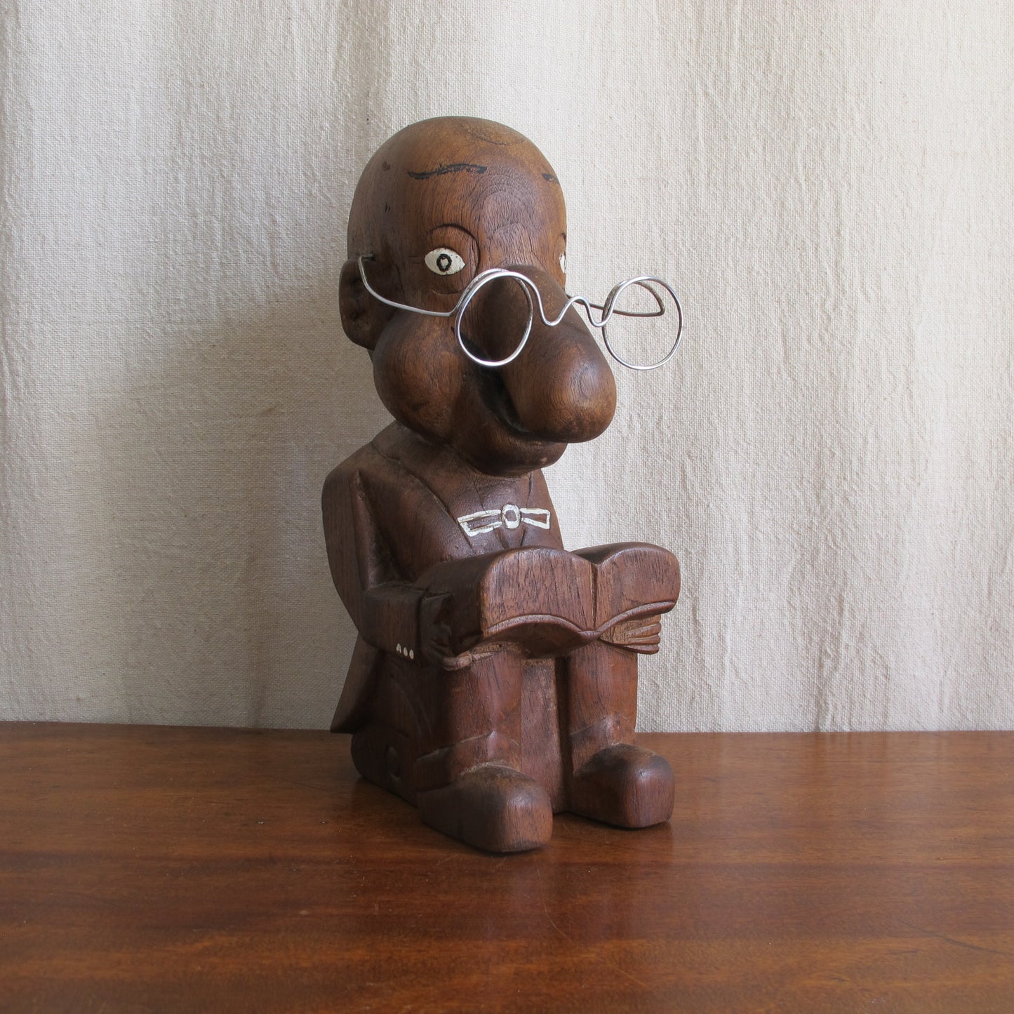 3D caricature of an unknown sitter or character, seated reading with a bulbous nose, suit with tails, glasses, c. 1930 vintage antique