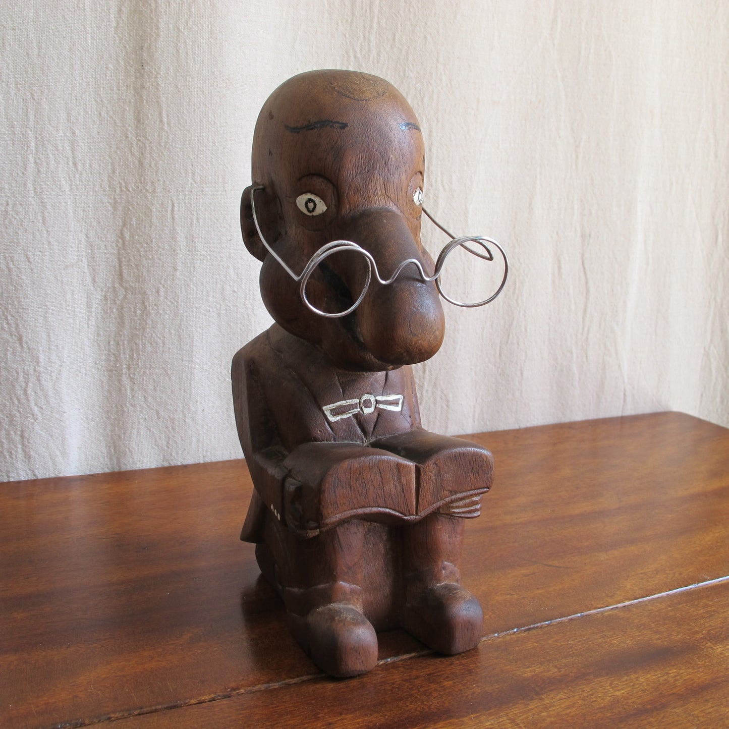 3D caricature of an unknown sitter or character, seated reading with a bulbous nose, suit with tails, glasses, c. 1930 vintage antique